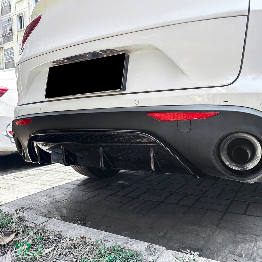 Car rear bumper with exhaust pipe on a paved surface