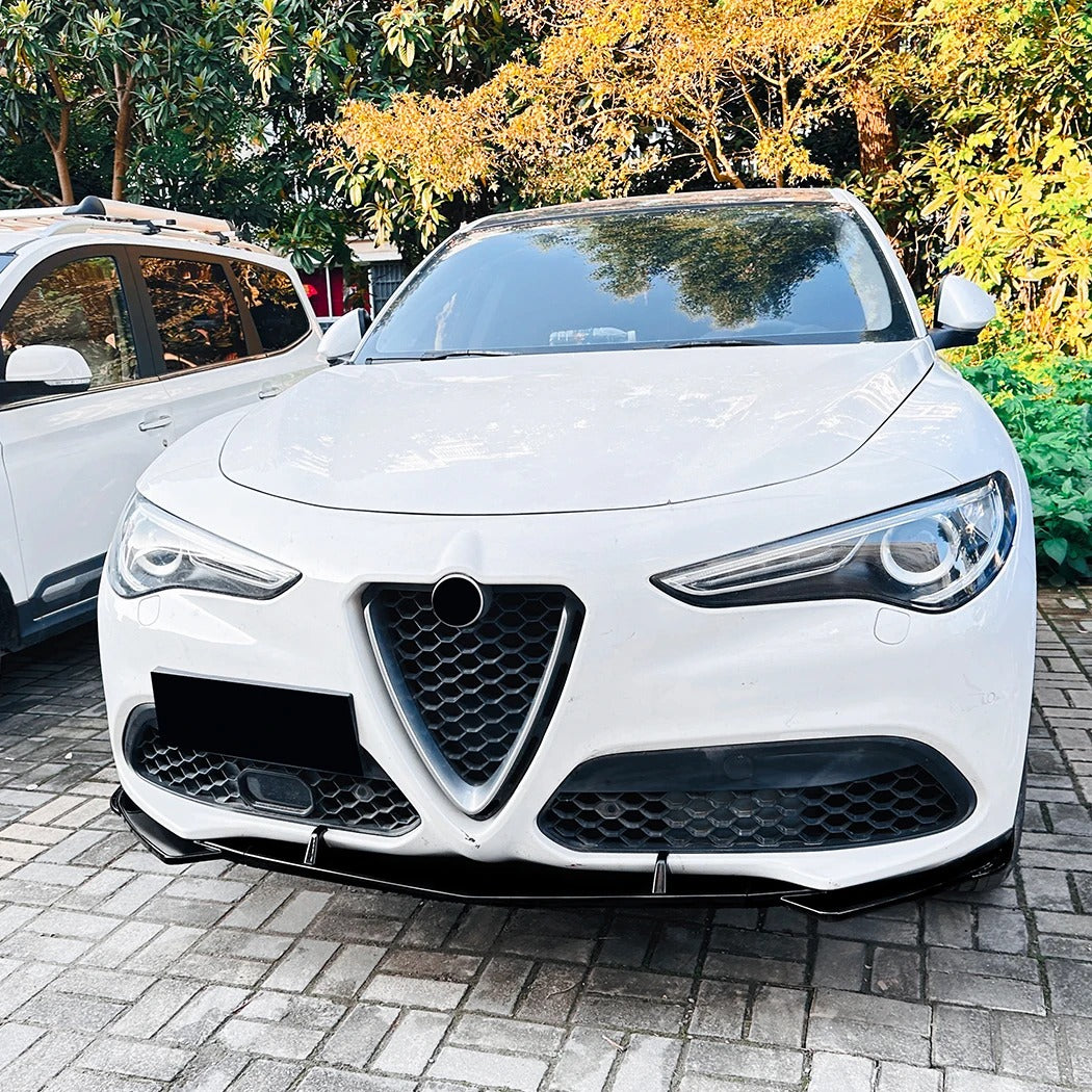 White Alfa Romeo car parked on a brick driveway with trees in the background