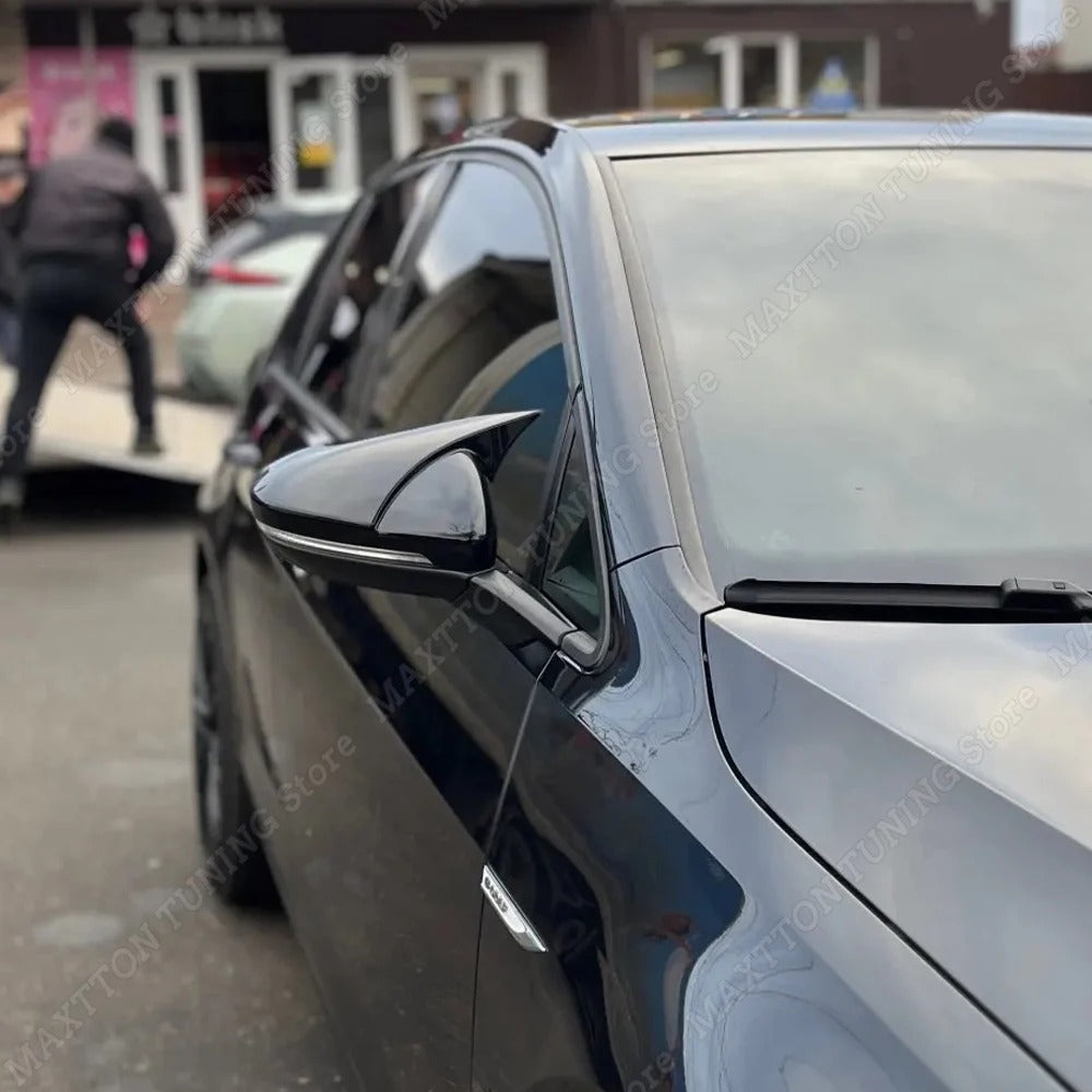 Car side mirror with a blurred background of a store front