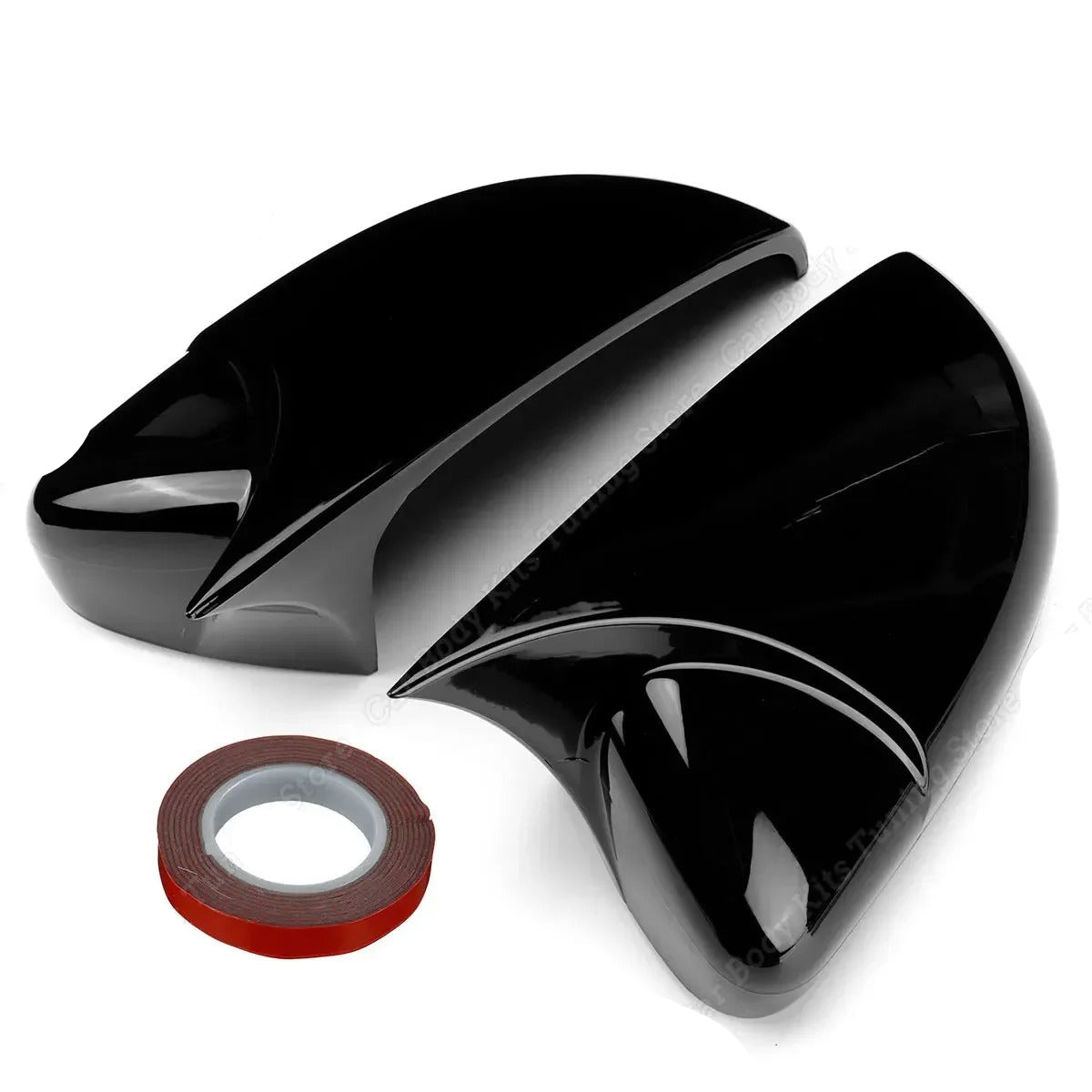 Two black motorcycle fairing panels with a roll of double-sided tape on a white background