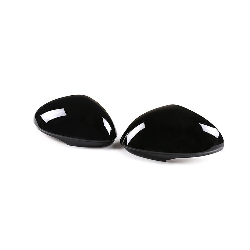 Two black triangular car mirror covers on a white background