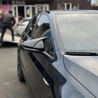 Car side mirror with a blurred background of a store front