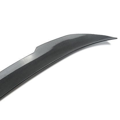 This Photo shows a carbon fiber spoiler with a white background