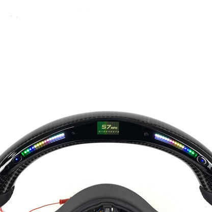 Carbon fiber rim with digital display on a white background, labeled 'Real Carbon'.