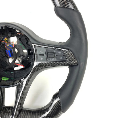 Carbon fiber steering wheel with buttons on a white background, labeled 'Real Carbon'.